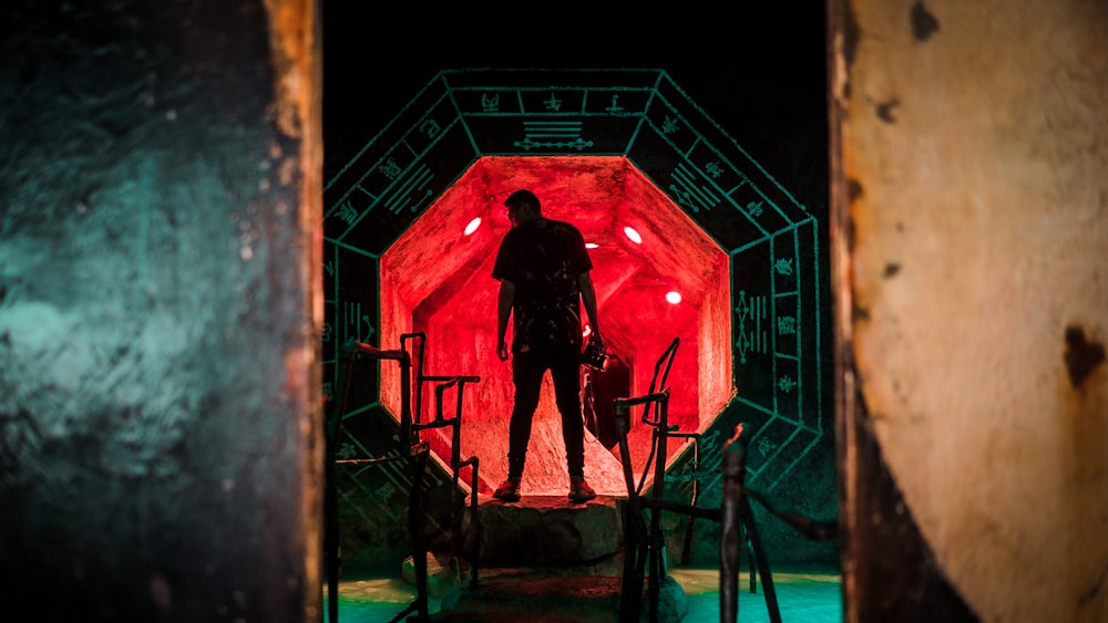 man standing in octagonal tunnel