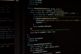 An instructor guiding students through programming code on a large screen