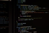 Computer screen displaying lines of code written in a dark-themed code editor. The code features syntax highlighting with text in various colors for different programming elements.