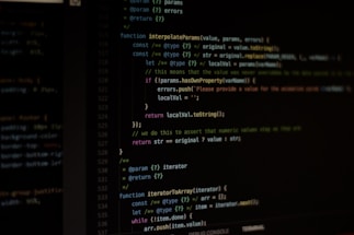 Computer screen displaying lines of code written in a dark-themed code editor. The code features syntax highlighting with text in various colors for different programming elements.