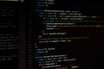 An instructor guiding students through programming code on a large screen