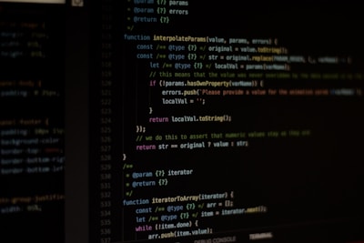 Computer screen displaying lines of code written in a dark-themed code editor. The code features syntax highlighting with text in various colors for different programming elements.