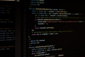Computer screen displaying lines of code written in a dark-themed code editor. The code features syntax highlighting with text in various colors for different programming elements.