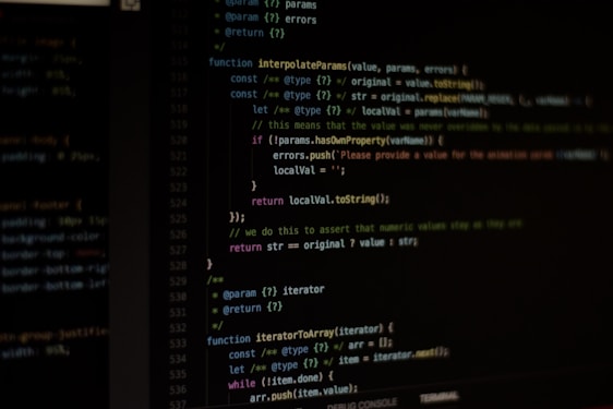 Computer screen displaying lines of code written in a dark-themed code editor. The code features syntax highlighting with text in various colors for different programming elements.