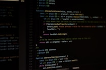 Computer screen displaying lines of code written in a dark-themed code editor. The code features syntax highlighting with text in various colors for different programming elements.