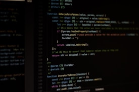 Computer screen displaying lines of code written in a dark-themed code editor. The code features syntax highlighting with text in various colors for different programming elements.
