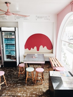 A cozy café interior with light pink and white decor.