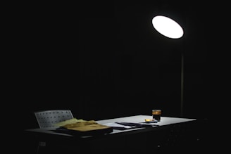 A colorful animated scene of a writer's desk with glowing scripts and dancing fireflies.