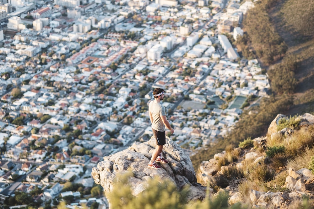 man standing near mountain cliff