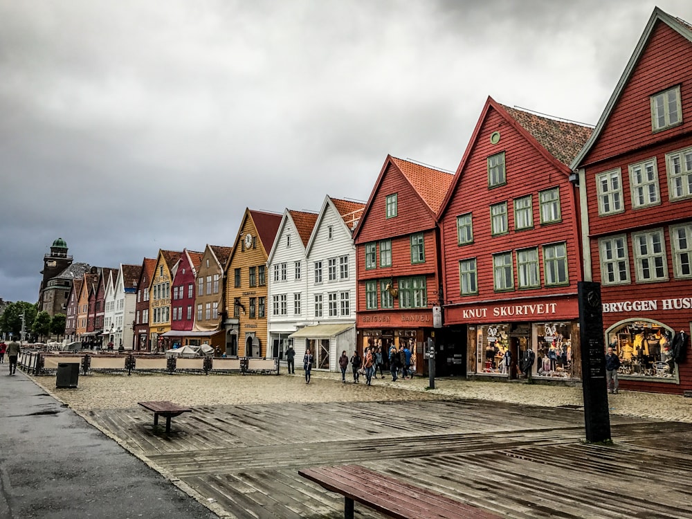 people standing near concrete houses