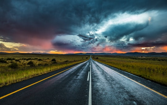 asphalt road under nimbus cumulus in Nieu-Bethesda South Africa