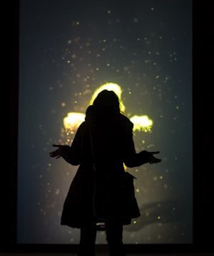 Visual of a user interacting with glowing, translucent creatures layered over a city park scene.