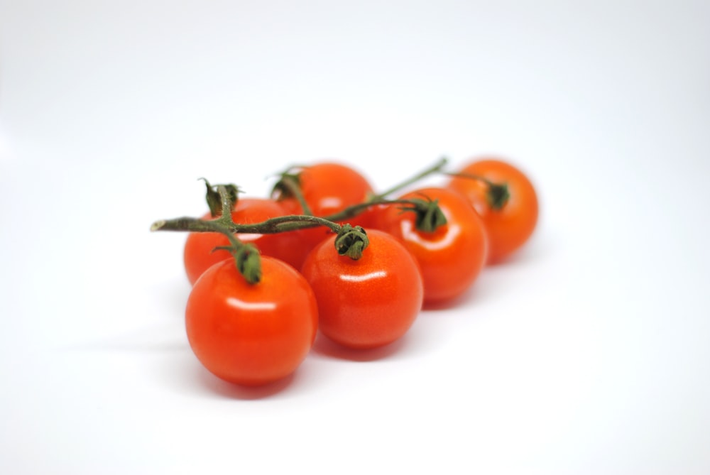 orange fruits on white surface