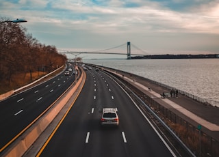 car on road near body of water