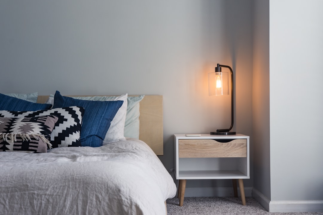  black table lamp on nightstand bed