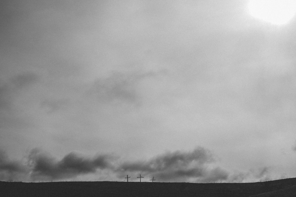 three cross under cloudy sky
