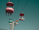 people on assorted-color cable cars at daytime