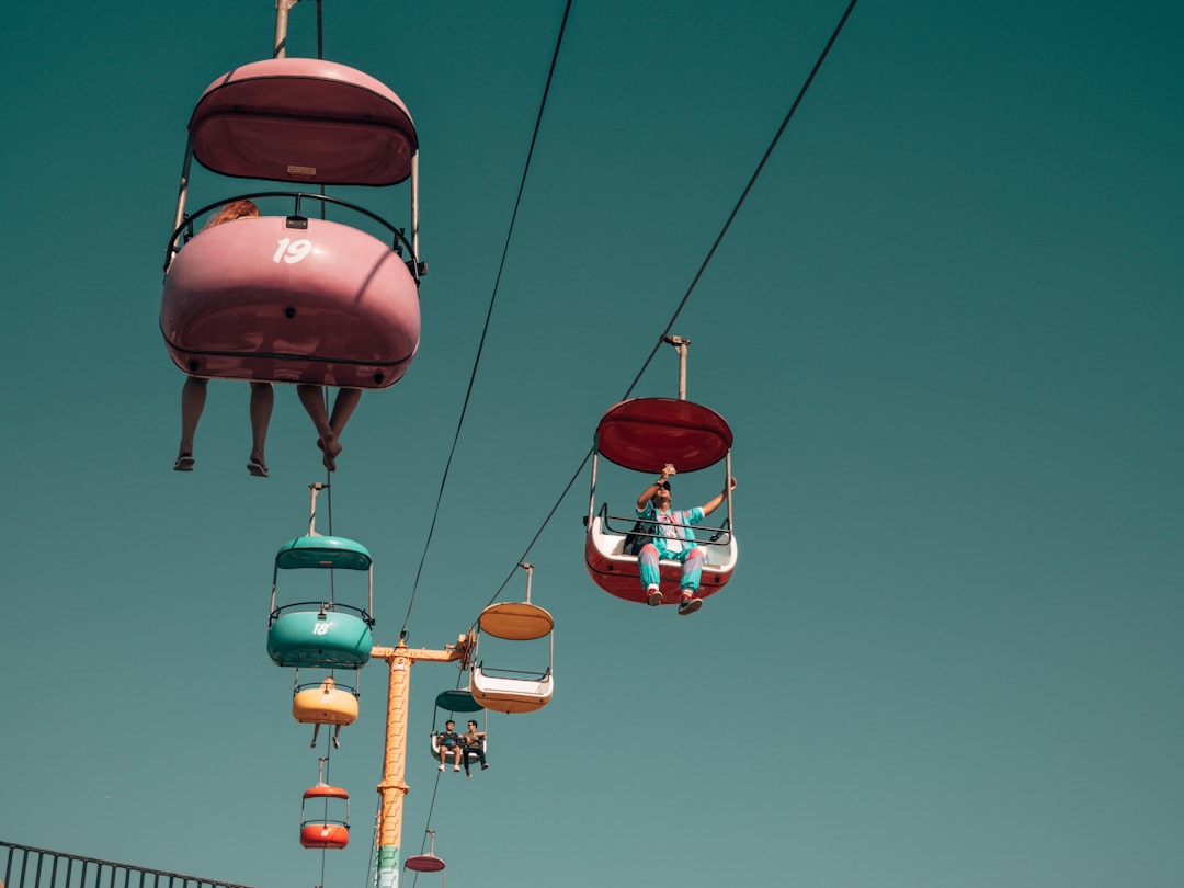 people on assorted-color cable cars at daytime, Dude matched the jumpsuit to the ride. Fresh.