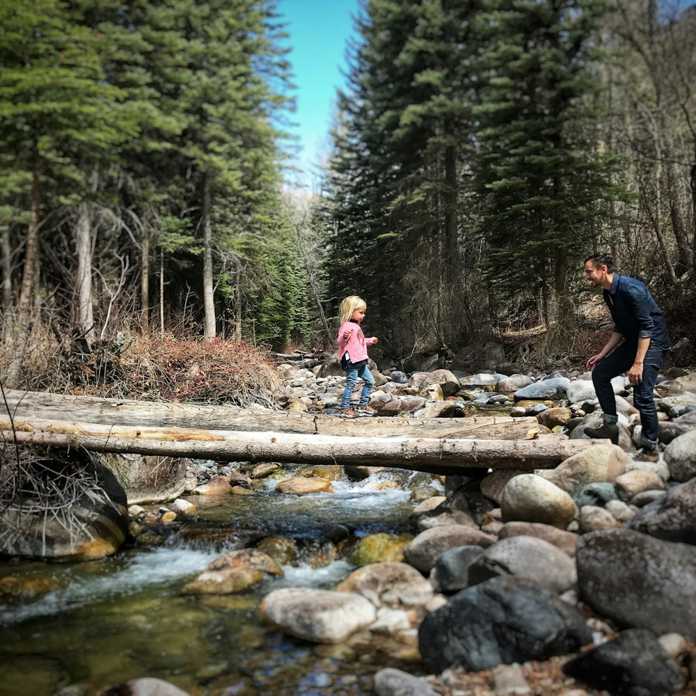 girl crossing wood lumber bridge