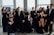A diverse group of people enjoying an elegant evening event with soft lighting and warm smiles.
