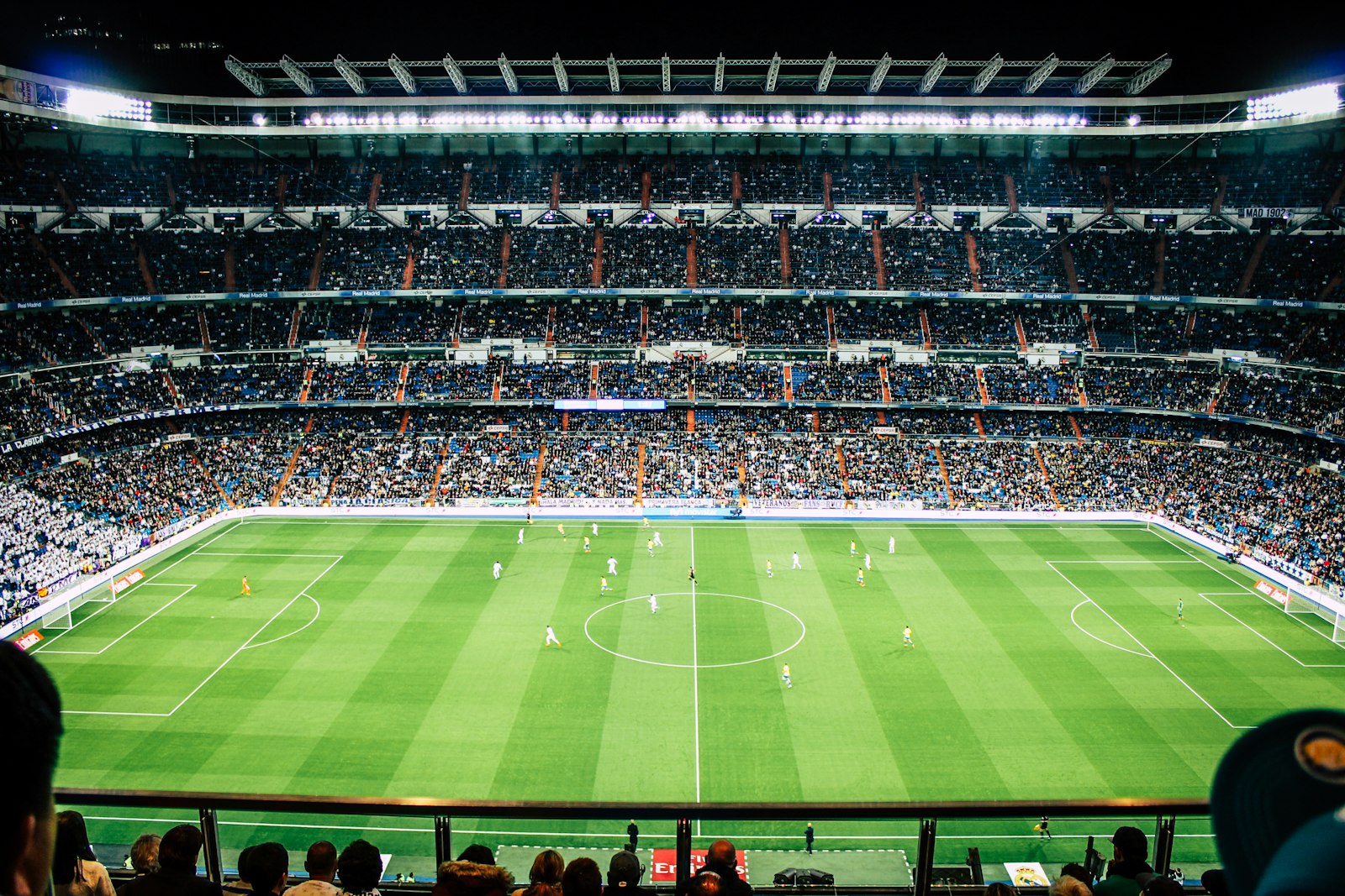 Floodlit stadium filled with supporters