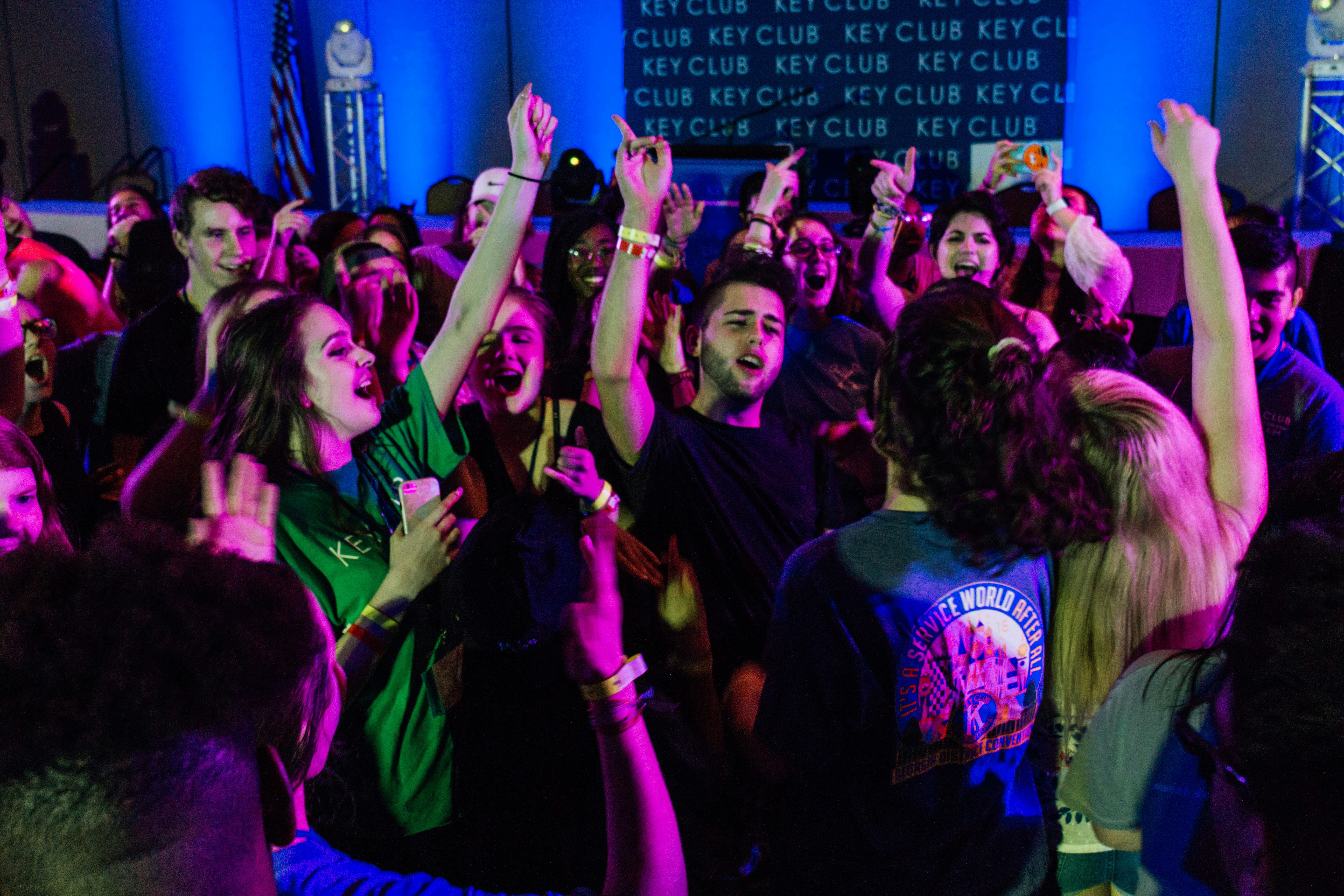 group of people raising their hands