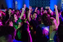 group of people raising their hands