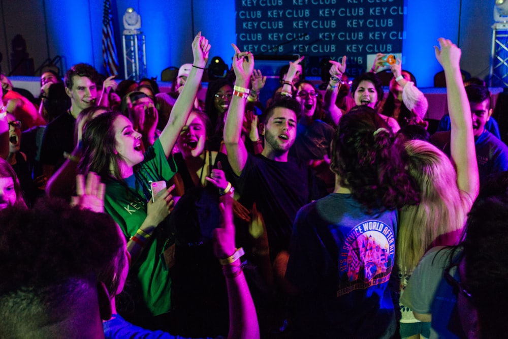 group of people raising their hands