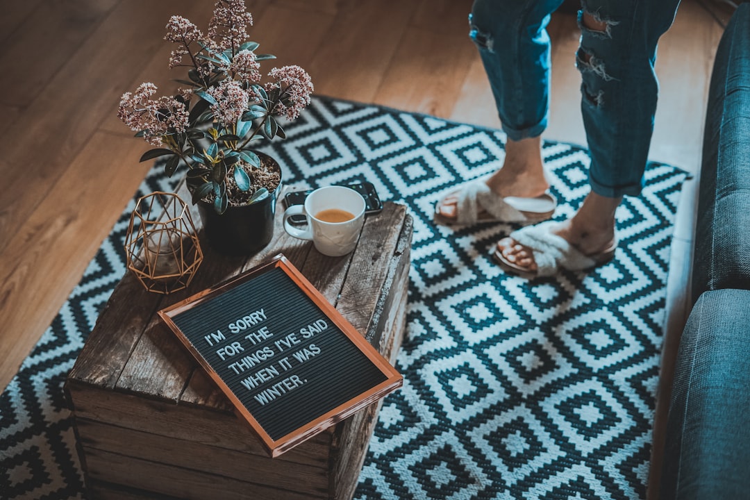 framed sorry quote on table beside half-filled mug, I’m sorry