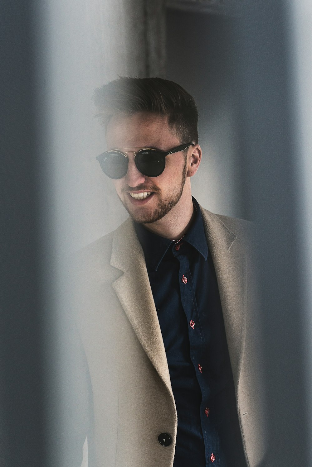 man standing beside wall