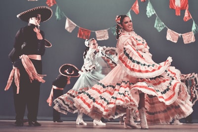 dancing women and men on stage mariachi teams background