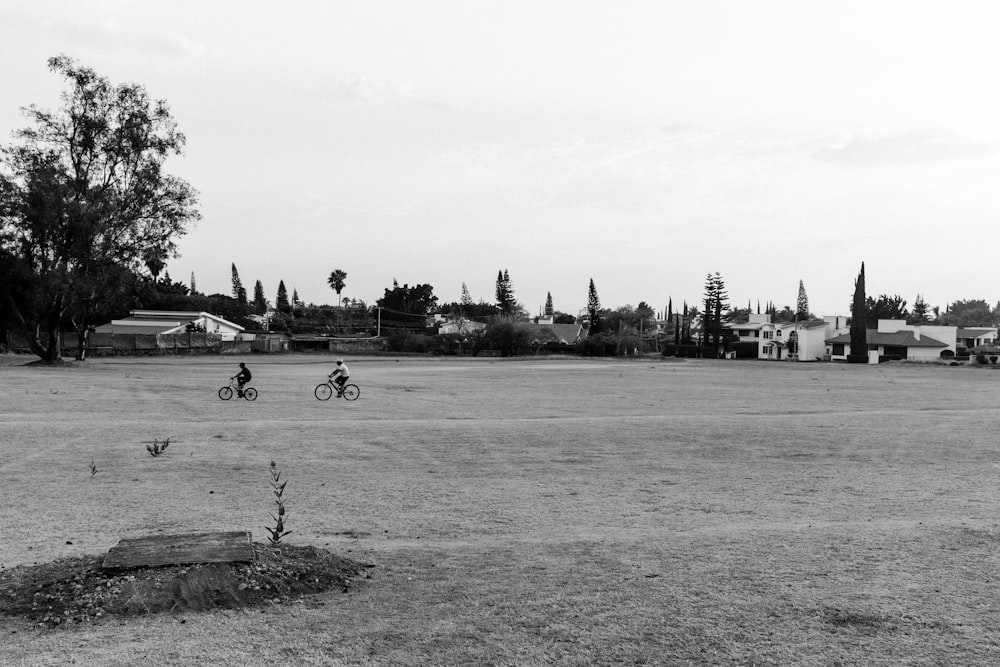 two person riding bikes playing on field