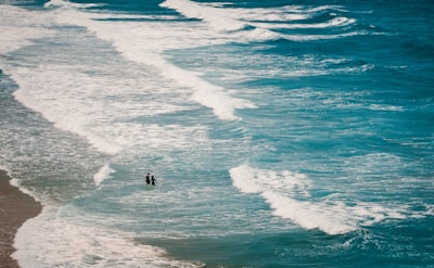 two persons walking on seashore seascape google meet background