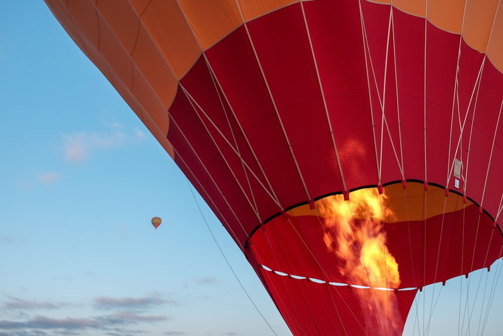 red hot air balloon during daytime