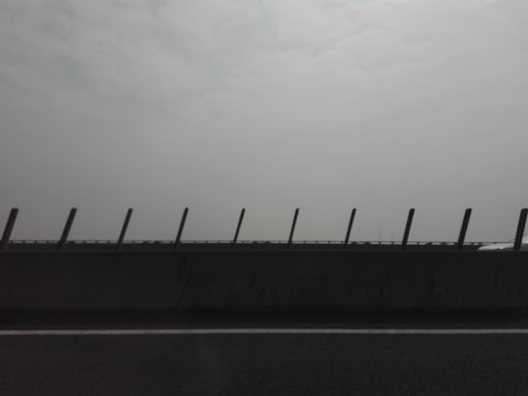 A crash barrier machine in operation on a highway.