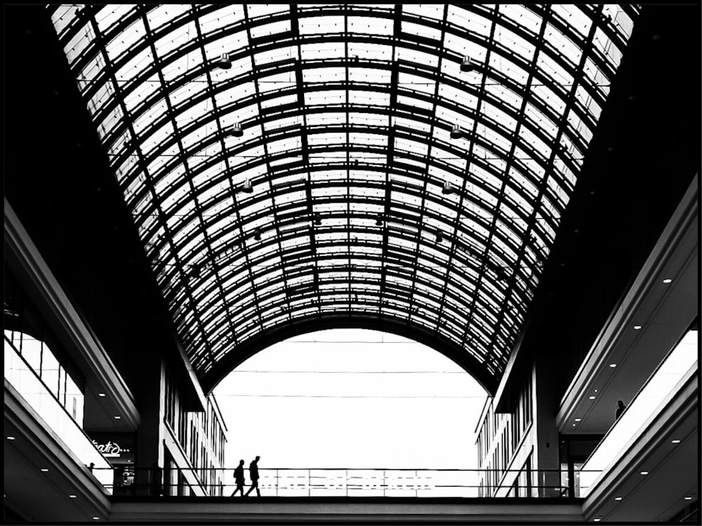 two people walking inside building