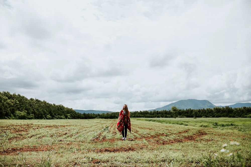 woman standing on green field