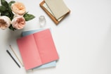 An open notebook with spiritual notes and a crystal beside it.