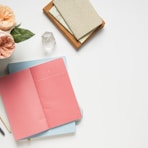 pink covered book in top view photography