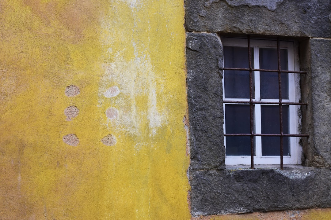 white window frame on yellow painted wall