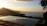 A serene sunset view from the villa's infinity pool overlooking lush gardens.