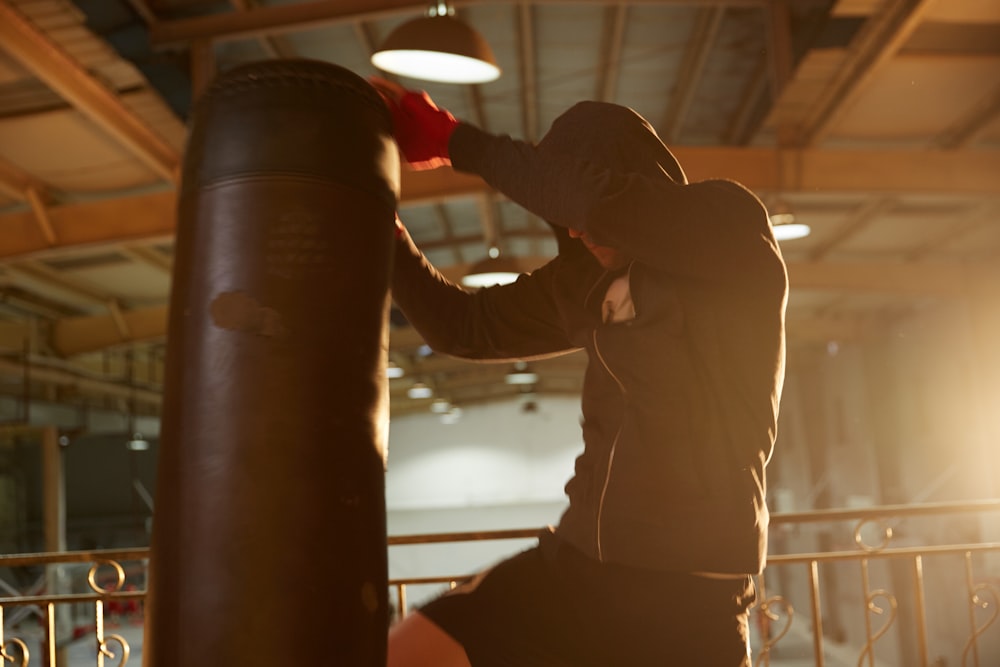 man kicking the heavy bag