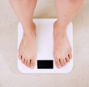 person standing on white digital bathroom scale