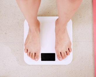 person standing on white digital bathroom scale