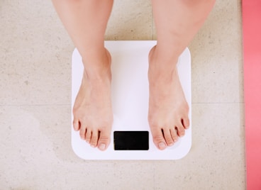 person standing on white digital bathroom scale