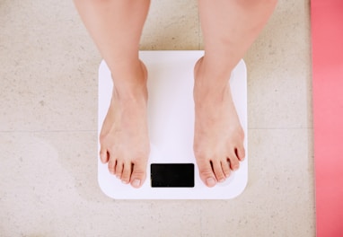 person standing on white digital bathroom scale