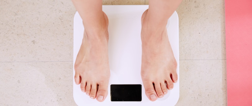 person standing on white digital bathroom scale