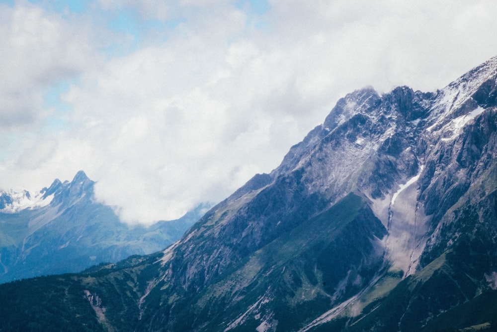 gray and green mountains under white clouds