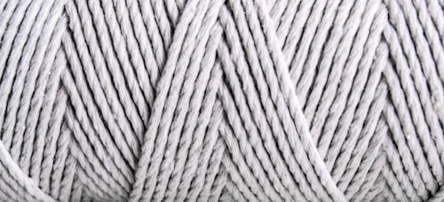 Close-up view of tightly wound, light gray yarn with visible texture and patterns formed by the twisted strands.