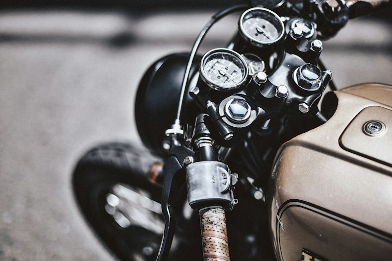 Motociclista pilotando café racer em estrada aberta